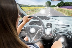Self-driving car concept - woman driving modern car