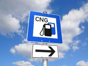 A sign that says "CNG" and has an arrow to signal a natural gas fueling station.