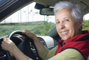 Happy senior woman out for a drive